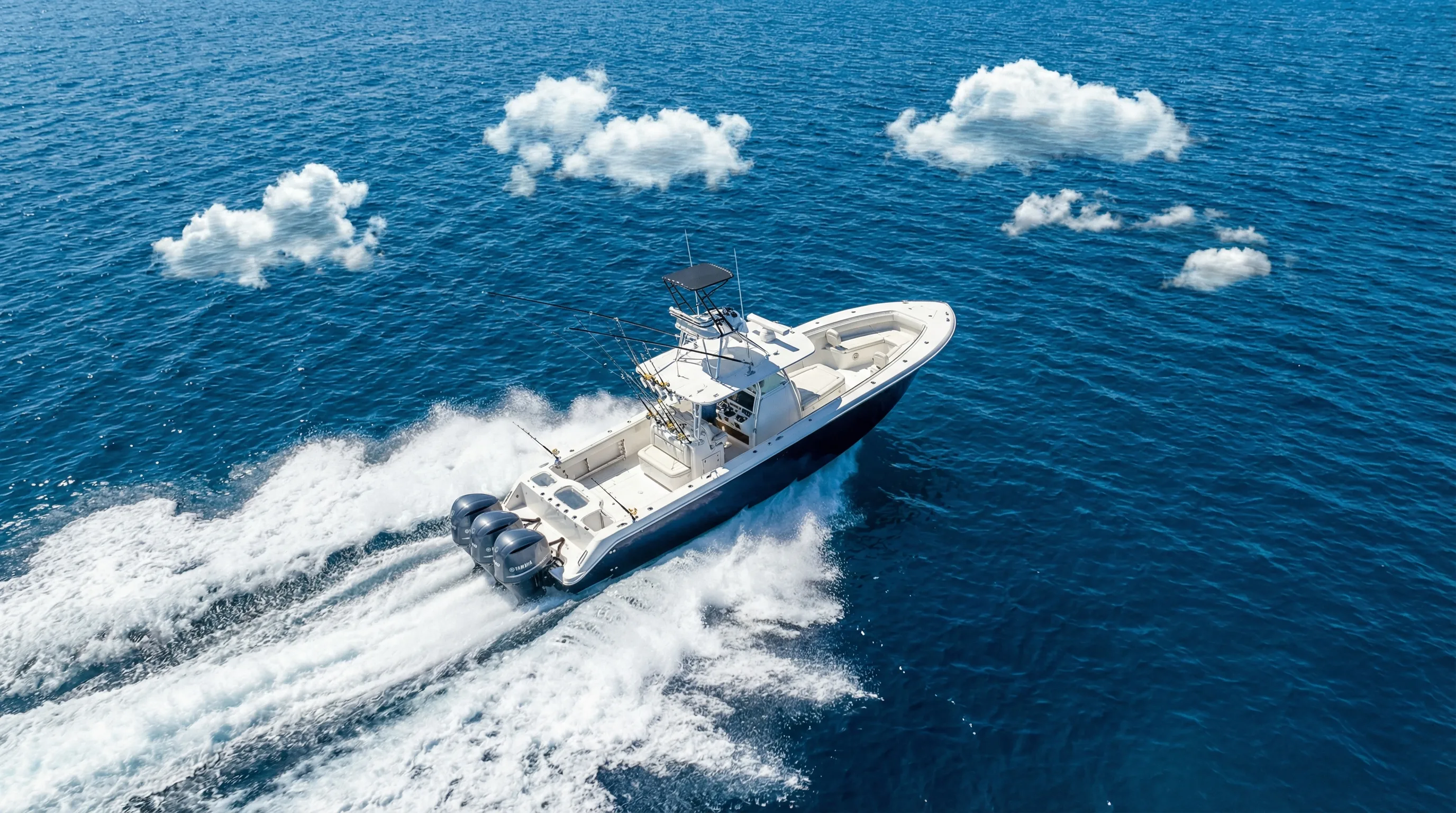 Center console fishing boat racing across open blue water